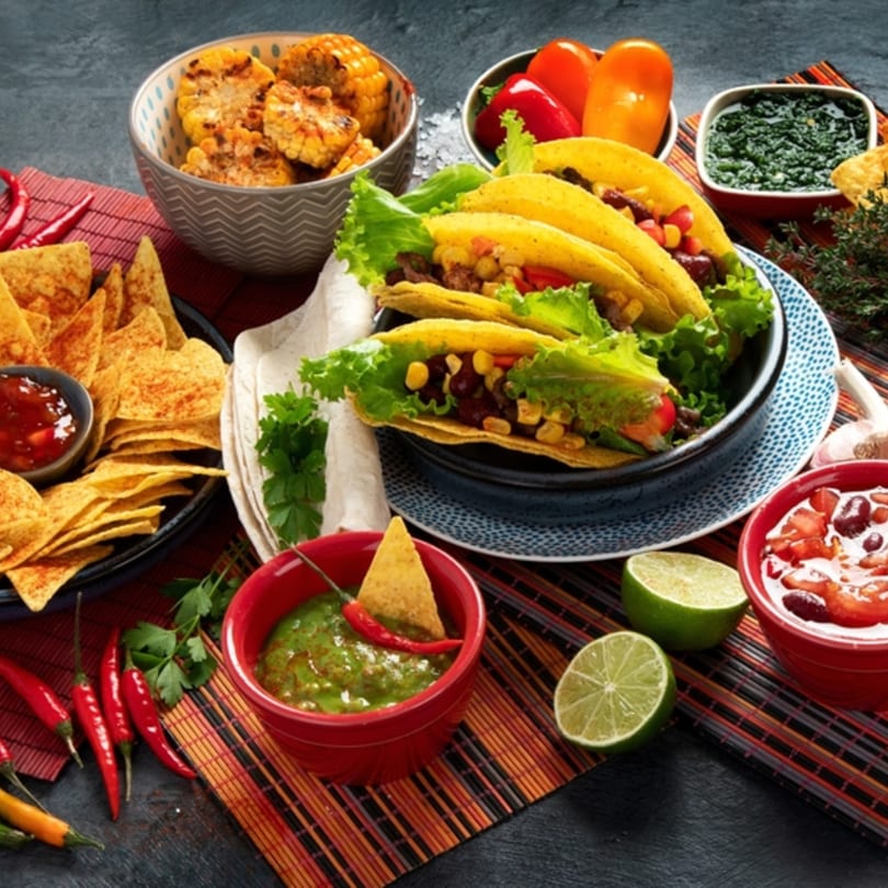 Mi Casita's Mexican feast with tacos, nachos, grilled corn, salsa, guacamole, and fresh ingredients.